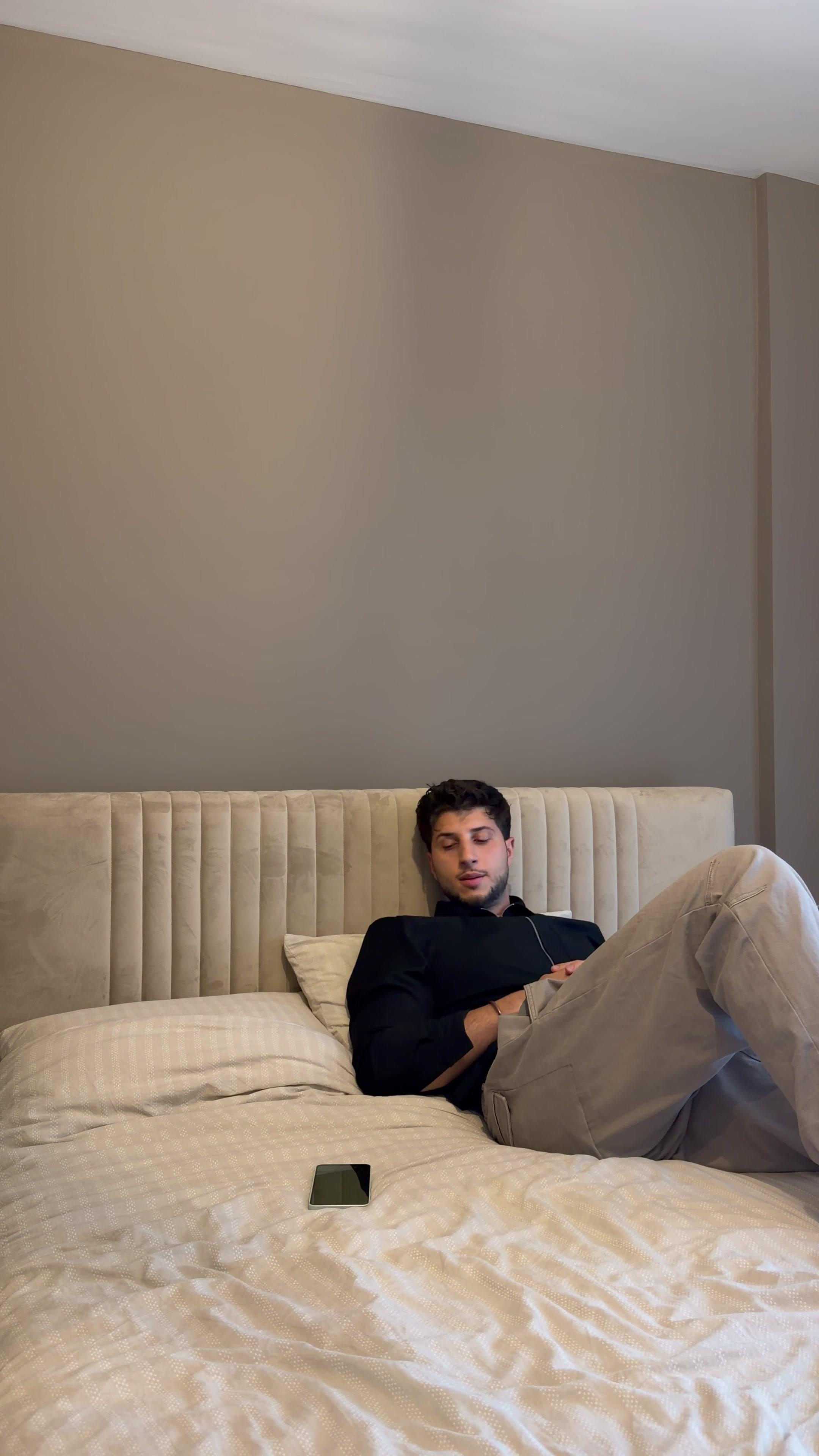 Man Waiting for Message Smiles at Phone