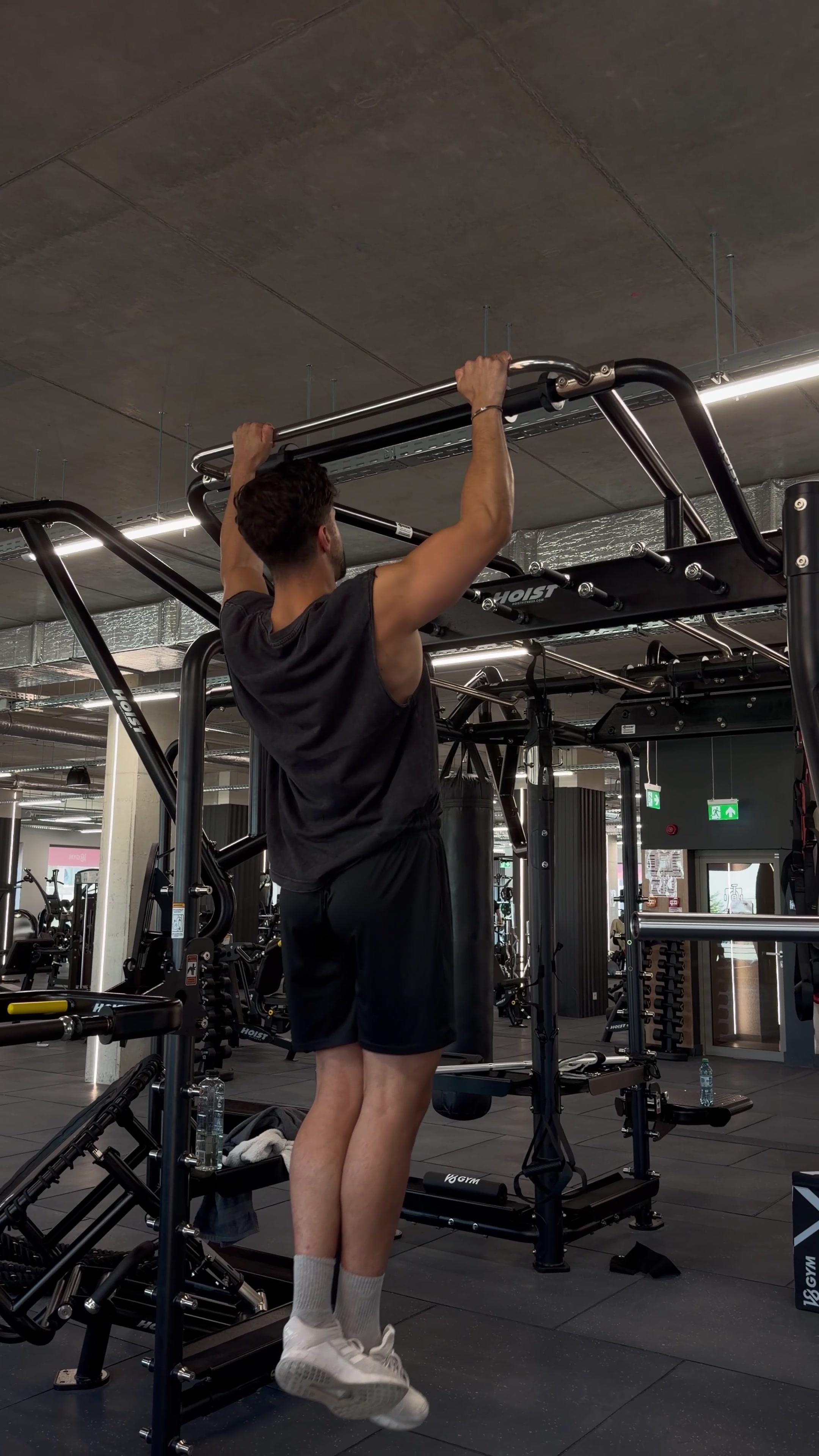 Man Performing Pull-Ups at the Gym