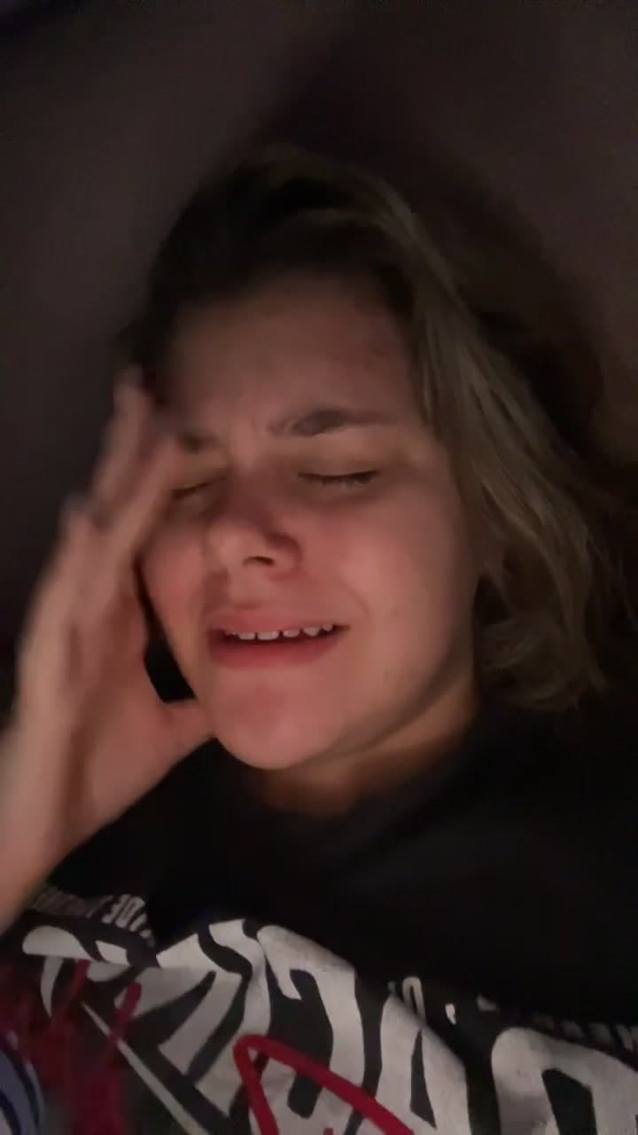 Young woman crying while lying down