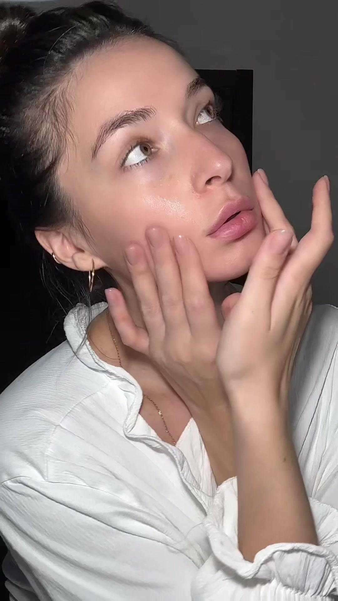 Woman Massaging Face and Jawline