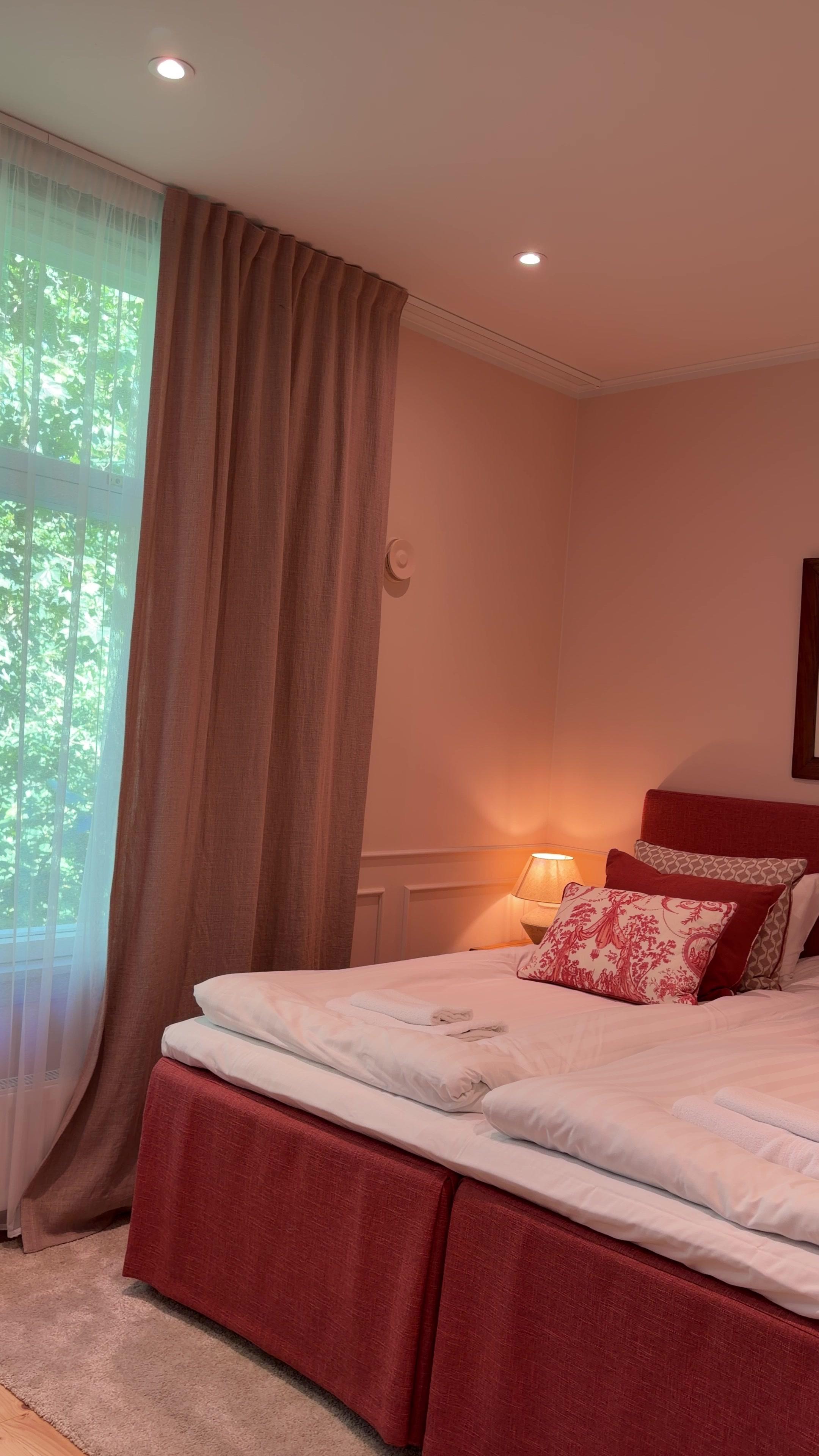 Woman Opening Hotel Room Curtains