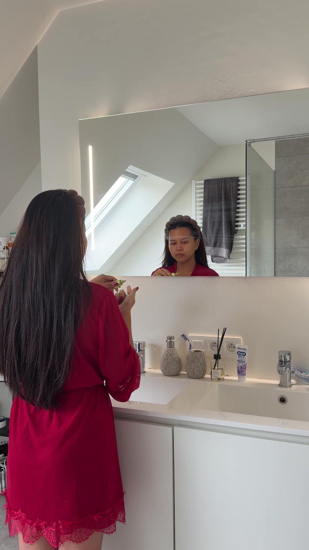 Woman Applying Face Serum in Bathroom